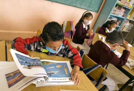 Pupils attend a class at a primary school in Mexico City, capital of Mexico, on May 11, 2009. Most of Mexican pre-school educational institutions as well as primary and secondary schools resume classes May 11 after days of closure due to the influenza epidemic.