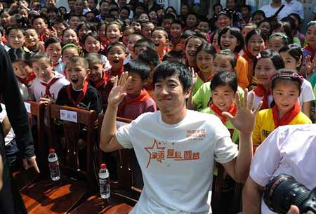 Chinese hurdler Liu Xiang poses for photgraphs with quake zone pupils at a primary school in Beichuan County, southwest China's Sichuan Province, on Monday May 11, 2009. 
