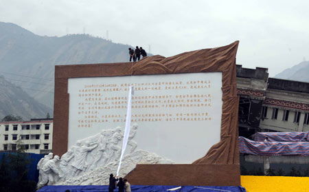 Working staff do final preparation work for the ceremony to mark the first anniversary of the devastating Wenchuan earthquake in Yingxiu Township of Wenchuan County, southwest China's Sichuan Province, on May 12, 2009. China will mark the anniversary of last year's devastating earthquake Tuesday afternoon with commemorative activities to be held in the epicenter Yingxiu Township.