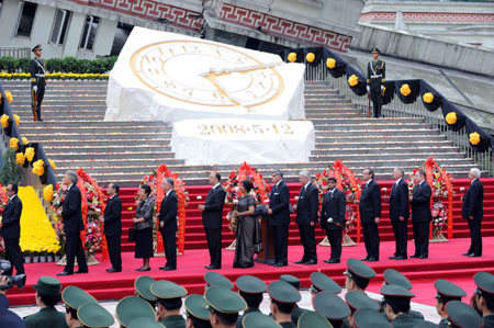 Foreign diplomats present flowers during the commemorative service to mark the first anniversary of May 12 Earthquake in Yingxiu Township of Wenchuan County, southwest China's Sichuan Province, on May 12, 2009.