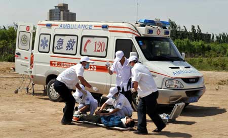Medical staff members attend a quake rescue drill in Yinchuan, capital of Ningxia Hui Autonomous Region, northwest China, on May 12, 2009, China's first National Disaster Prevention and Reduction Day on the occasion of the first anniversary of the May 12, 2008 Wenchuan earthquake.