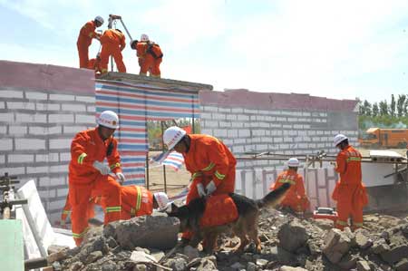 Firefighters attend a quake rescue drill in Yinchuan, capital of Ningxia Hui Autonomous Region, northwest China, on May 12, 2009, China's first National Disaster Prevention and Reduction Day on the occasion of the first anniversary of the May 12, 2008 Wenchuan earthquake.