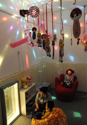 A teacher accompanies her students with infantile autism in a special education nursery school in Shenyang, on May 13, 2009. The nursery school started in 1994, and has taught some 1000 disabled students during the past 15 years. 