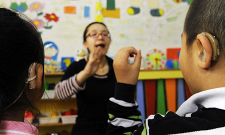 Zhe Ping teaches her deaf students to pronounce in a special education nursery school in Shenyang, on May 13, 2009. The nursery school started in 1994, and has taught some 1000 disabled students during the past 15 years.