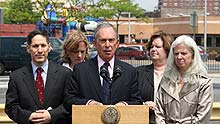 New York City Mayor Bloomberg (C) talks to the media outside the Pop Diner restaurant in Queens borough of New York, the US, on May 15, 2009.