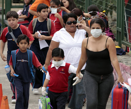 Students of a school wear masks to prevent the A/H1N1 flu in Guayaquil, Ecuador, on May 15, 2009.