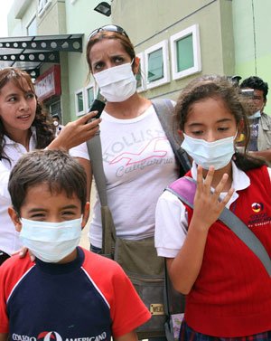 Students of a school wear masks to prevent the A/H1N1 flu in Guayaquil, Ecuador, on May 15, 2009.