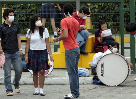 Students of a school use masks to prevent the A/H1N1 flu in Guayaquil, Ecuador, on May 15, 2009. 