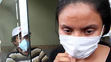 A woman leaves hospital with a mask to prevent the A/H1N1 flu in Guayaquil, Ecuador, on May 15, 2009. Health authorities on Friday confirmed the first case of A/H1N1 flu identified on a child of twelve years old.