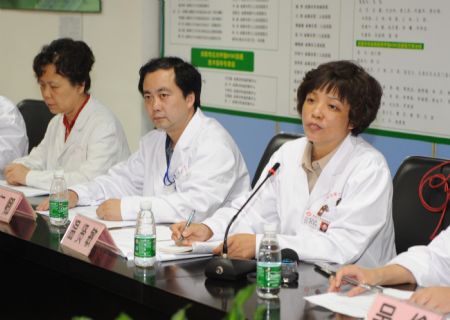 Director of Chengdu Infectious Diseases Hospital Wen Xianmin (R) speaks at a panel meeting in Chengdu, capital of southwest China's Sichuan Province, on May 17, 2009. The patient surnamed Bao, who was China's first patient in the case of A/H1N1 flu, was discharged from hospital Sunday after recovery, local authorities said.