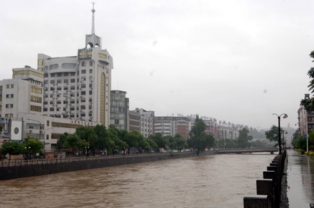 Flood water runs down a river in Chenzhou City, south China&apos;s Hunan Province, on May 20, 2009 after heavy rain swept across provinces in south China for the second day. Agricultural crops in some rural areas were flood by the unexpected summer flood. 