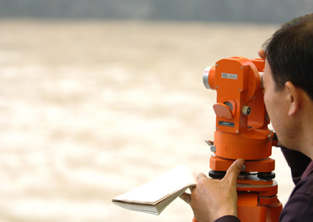 A local hydrologist staff observes the flood water level at a river in Chenzhou City, south China&apos;s Hunan Province, on May 20, 2009 after heavy rain swept across provinces in south China for the second day. 