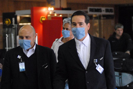 Crew members of MEXICANA walk out of an international airport in Buenos Aires, capital of Argentina, on May 20, 2009. An airplane of MEXICANA arrived in Buenos Aires on Wednesday, marking an official resumption of the straight flight between Argentina and Mexico due to the A/H1N1 flu influence for weeks.