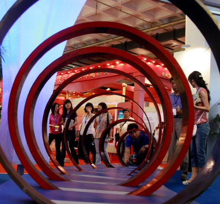 People visit steel tubes of special type made by Beijing Capital Steel Company at the 12th Beijing International Science and Technology Exposition held in Beijing, on May 20, 2009. 