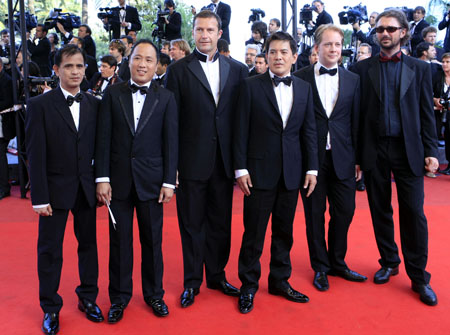 Filipino Brillante Mendoza and cast members of his movie 'Kinatay' arrive on the red carpet of the closing ceremony of the 62nd Cannes Film Festival in Cannes, southern France, on May 24, 2009. Brillante Mendoza won the best director award for his movie 'Kinatay.'
