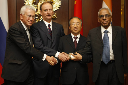 Chinese State Councilor Dai Bingguo (2nd R) poses for a group photo with Indian National Security Advisor R. K. Narayanan (1st R), minister of Strategic Affairs of Brazil Roberto Mangabeira Unger (1st L) and Russian Security Council Secretary Nikolai Patrushev after their meeting in Moscow, Russia, on May 29, 2009. 