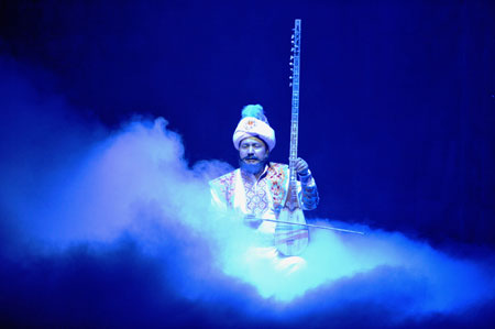 An actor performs the Uyghur Muqam in Urumqi, capital of Xinjiang Uygur Autonomous Region, northwest China, on May 27, 2009. Xinjiang Uyghur Muqam is a mixture of song, dance, folk and classical music.