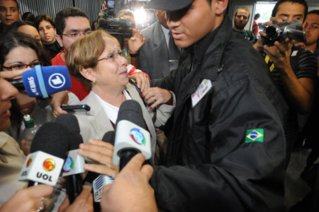 A relative of the missing airliner's victims is surrounded by journalists at the Rio de Janeiro International Airport, Brazil, on June 1, 2009. An Air France airliner with 228 people onboard missing over the Atlantic Ocean after its takeoff from Rio de Janeiro on Sunday was probably hit by lightning and suffered an electrics failure while flying through an Atlantic storm, said Air France on Monday.