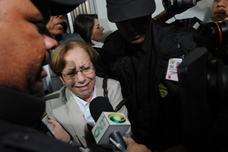 A relative of the missing airliner's victims leaves the Rio de Janeiro International Airport escorted by guards in Rio de Janeiro, Brazil, on June 1, 2009. An Air France airliner with 228 people onboard missing over the Atlantic Ocean after its takeoff from Rio de Janeiro on Sunday was probably hit by lightning and suffered an electrics failure while flying through an Atlantic storm, said Air France on Monday.