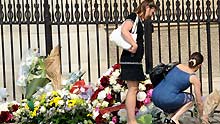 Two women place flowers to mourn for the 216 passengers and 12 crew members aboard the missing Airbus A330 during a memorial ceremony in front of Notre-Dame cathedral in Paris, capital of France, on June 3, 2009.