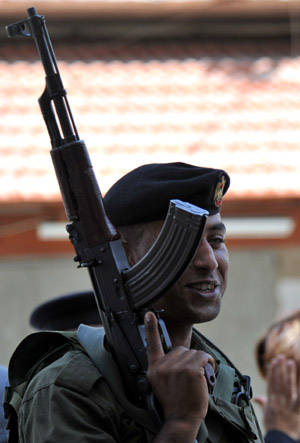 A Palestinian policeman patrols near the scene of the gunbattle in the northern West Bank city of Qalqilya on June 4, 2009. 