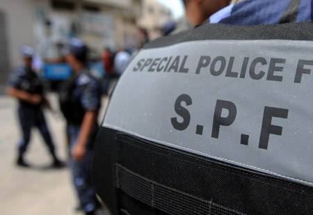 A Palestinian policeman patrols near the scene of the gunbattle in the northern West Bank city of Qalqilya on June 4, 2009.