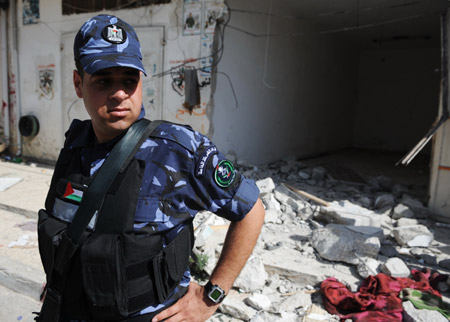 A Palestinian policeman guards at the scene of the gunbattle in the northern West Bank city of Qalqilya on June 4, 2009.