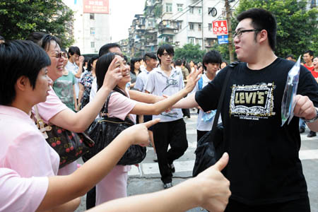 Teachers encourage a student at an exam site prior to the college entrance exam in Guangzhou, capital of south China's Guangdong Province, June 7, 2009. China's national college entrance exam kicked off on Sunday with about 10.2 million registered examinees.