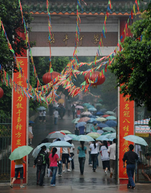 Chinese students walk to the examination rooms to attend the National College Entrance Examination, which will last until Tuesday for three days across China, in Qionghai city in south China's island province of Hainan, on June 7, 2009. Some 10.2 million Chinese school students are to compete this year in the world's largest annual examination for a quota of 6.29 million to learn in universities and colleges.