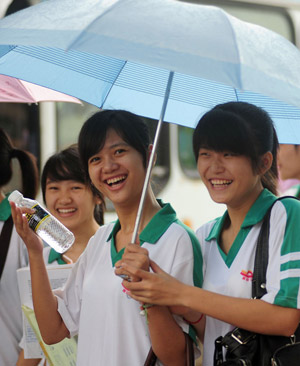 Chinese students walk to the examination rooms to attend the National College Entrance Examination, which will last until Tuesday for three days across China, in Qionghai city in south China's island province of Hainan, on June 7, 2009. Some 10.2 million Chinese school students are to compete this year in the world's largest annual examination for a quota of 6.29 million to learn in universities and colleges. 