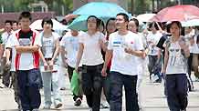 Chinese students and their family members walk home after they finished the first day tests of the National College Entrance Examination, which will last until Tuesday for three days across China, in Rui'an city in east China's Zhejiang province, on June 7, 2009. Some 10.2 million Chinese school students are to compete this year in the world's largest annual examination for a quota of 6.29 million to learn in universities and colleges.