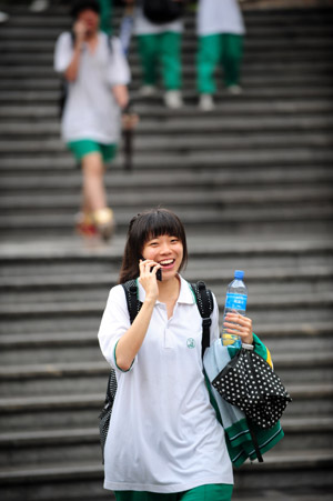 A student walks out after finishing her college entrance exam at a middle school in Guangzhou, capital of south China's Guangdong Province, on June 9, 2009. 