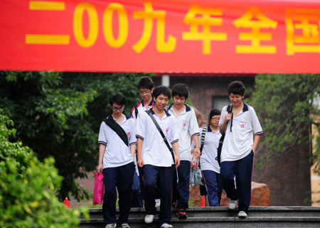 Students walk out after finishing their college entrance exam at a middle school in Guangzhou, capital of south China's Guangdong Province, on June 9, 2009. 