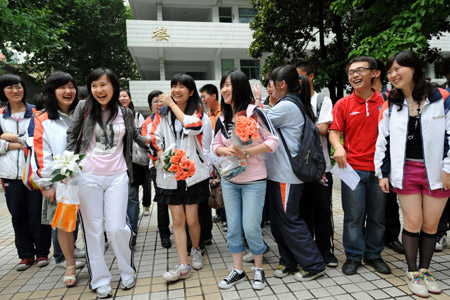 Students walk out after finishing their college entrance exam at a middle school in Nanjing, capital of east China's Jiangsu Province, on June 9, 2009.