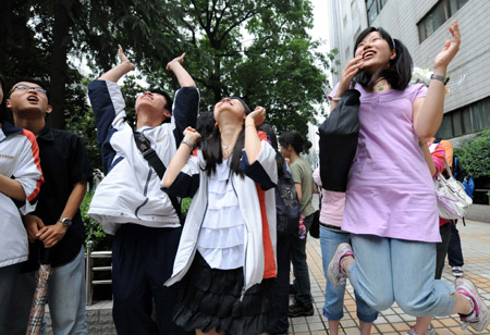 Students react after finishing their college entrance exam at a middle school in Nanjing, capital of east China's Jiangsu Province, on June 9, 2009. 