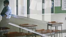 A teacher rests outside an empty classroom in the private Seisoku High School in Tokyo, capital of Japan, on June 12, 2009. The first A/H1N1 flu group infections in Tokyo were confirmed on Thursday, with nine students and three teachers of the high school in Minato Ward contracting the disease. The high school will be closed for one week from Thursday due to the outbreak.