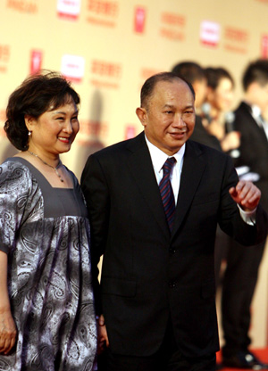 Director John Woo (R) and his wife arrive for the opening ceremony of the 12th Shanghai International Film Festival in east China's Shanghai, June 13, 2009.