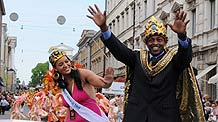 The queen and king of Samba carnival of Helsinki perform along a street in the center of Helsinki, capital of Finland, June 13, 2009. The 19th Samba Carnival was held in Helsinku on Saturday, attracting thousands of people to participate in this festival.