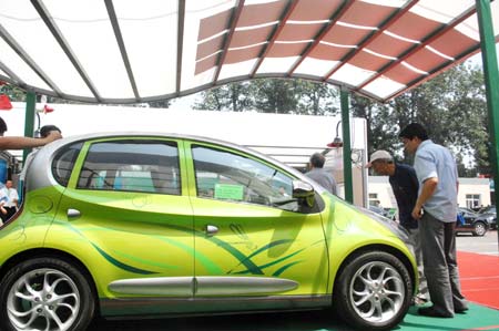 Visitors view the environment-friendly car at the China International Energy Saving and Environmental Protection Exhibition 2009 in Beijing, capital of China, on June 14, 2009. The exhibition kicked off on Sunday and attracted over 250 enterprises from home and abroad. 