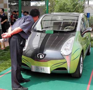 A visitor views the environment-friendly car at the China International Energy Saving and Environmental Protection Exhibition 2009 in Beijing, capital of China, on June 14, 2009. The exhibition kicked off on Sunday and attracted over 250 enterprises from home and abroad. 