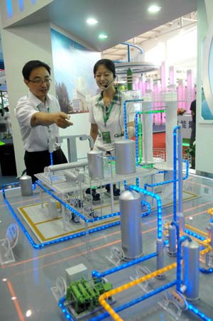 A worker introduces an engineering model to a visitor at the China International Energy Saving and Environmental Protection Exhibition 2009 in Beijing, capital of China, on June 14, 2009. The exhibition kicked off on Sunday and attracted over 250 enterprises from home and abroad. 