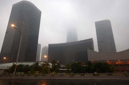 The street lamps are turned on along eastern Chang'an street in Beijing, China, on June 16, 2009. Local authority released a yellow alert for lightings on Tuesday.