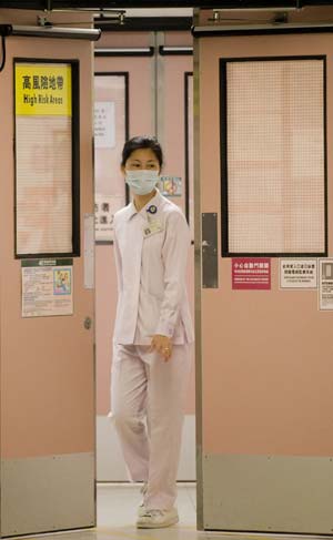 A nurse leaves an isolation ward at a hospital in south China's Hong Kong, on June 18, 2009. Forty-nine new influenza A/H1NI cases were confirmed in Hong Kong on Thursday, bringing the city's tally to 221, Hong Kong's Department of Health announced. 