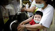 A child washes his hands at a hospital in south China's Hong Kong, on June 18, 2009. Forty-nine new influenza A/H1NI cases were confirmed in Hong Kong on Thursday, bringing the city's tally to 221, Hong Kong's Department of Health announced.