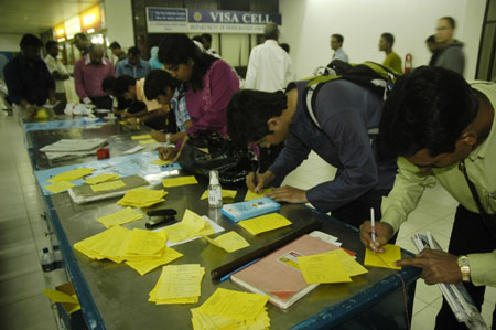 Passengers fill in 'Self Declaration of A/H1N1 Flu Status' papers at Zia International Airport in Dhaka, capital of Bangladesh, on June 19, 2009. 