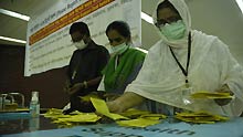 Health workers sort out 'Self Declaration of A/H1N1 Flu Status' papers at Zia International Airport in Dhaka, capital of Bangladesh, on June 19, 2009. The first A/H1N1 flu case has been detected in Bangladesh, the country's health ministry said in a press release on Friday.