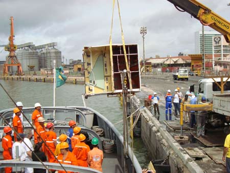 A handout picture released by the Brazilian Navy shows recovered debris of the Air France aircraft lost in midflight over the Atlantic Ocean on June 1 being downloaded from a Brazilian Navy Corvette to the banks at Recife's harbour on June 19, 2009. 