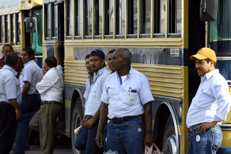 Workers of a General Motor (GM) assembly plant wait outside the factory to go home in Valencia, Venezuela, on June 19, 2009. The assembly plant was temporarily shut down for 3 months because it cannot import car parts timely. 