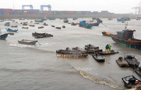 Fishing boats are moored as people brace for the upcoming Linfa, the third tropical storm this year, at a port in Jinjiang, a city in southeast China's Fujian Province, on June 21, 2009. Linfa has upgraded to strong tropical storm on June 20, and an emergency alarm was issued by the provincial weather bureau.