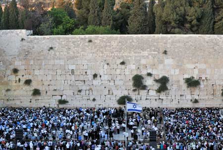 Demonstrators gather for a rally to denounce Israeli government's policy on Jewish settlements, at the Western Wall in Jerusalem's Old City on June 21, 2009. Israeli Prime Minister Benjamin Netanyahu vowed in a keynote speeck on June 14 that Israel would not build any new settlements and would refrain from expanding existing Israeli communities in the West Bank. 